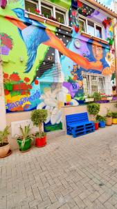 a mural on the side of a building with plants at Jara Apartments ! in Málaga