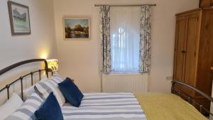 a bedroom with a bed and a window at Mountain View in Ulverston