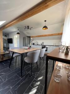 a kitchen with a wooden table and chairs at Die Loft in Kemnath