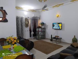 a living room with a couch and a tv at Globe-trotter vision A in Cotonou
