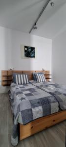 a bedroom with a bed with a black and white comforter at Stella Baltic 26 in Świnoujście