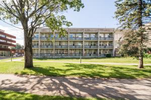 an apartment building with trees in front of it at Abilana in Palanga