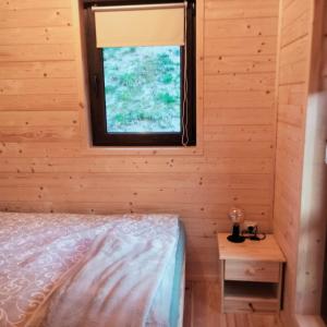 a bedroom with a bed and a window at Pod Bercem in Solina