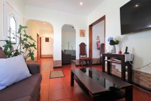 een woonkamer met een bank en een tafel bij Casa Quinta das Férias in Ginetes