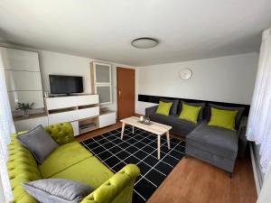 a living room with a couch and a table at Apartament 2 pokoje 45m2 - 200 metrów od morza in Międzyzdroje