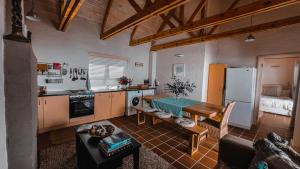 a kitchen with a table and a refrigerator at Villa Paulina Cottage in Langebaan