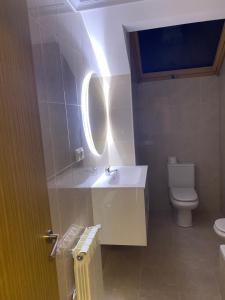 a bathroom with a sink and a toilet at Apartamento Turistico Mirador de Valdellera I in Posada de Llanes +14 photos