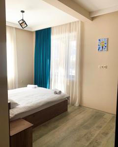 A bed or beds in a room at Hotel Axien Kazbegi