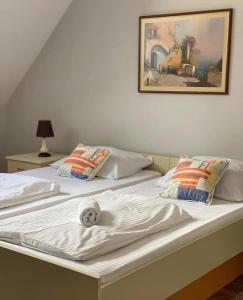 a pair of beds with a ball on top of them at Apartment Aleksandra in Bajina Bašta