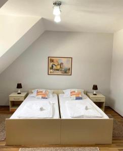 a bedroom with two beds and two night stands at Apartment Aleksandra in Bajina Bašta