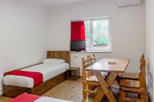 a bedroom with a bed and a table and a window at Family Appartments on Buzand street in Yerevan