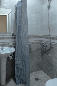 a shower curtain in a bathroom with a sink at Family Appartments on Buzand street in Yerevan