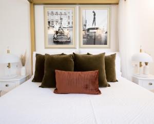 a white bed with a red pillow on top of it at Apartments Mediteraneo in Vrsar