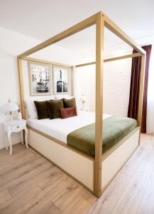 a bedroom with a canopy bed in a room at Apartments Mediteraneo in Vrsar