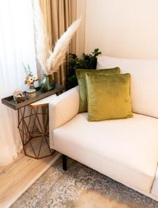 a white couch with a yellow pillow in a living room at Apartments Mediteraneo in Vrsar