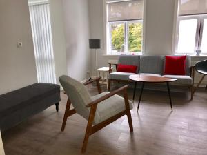 a living room with a couch and a table and chairs at Day Dream Soleyjargata Rooms & Apartments in Reykjavík