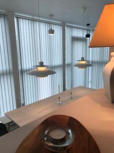 a dining room with a table with three lights at Day Dream Soleyjargata Rooms & Apartments in Reykjavík