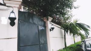 a garage door with two lights on the side of a house at Appartement haut standing avec piscine in Yaoundé