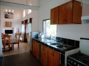 a kitchen with a sink and a stove at Appartement haut standing avec piscine in Yaoundé
