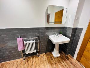 a bathroom with a sink and a mirror at Lavender Retreat in Wrexham