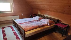a bedroom with a bed in a wooden room at Apartment V&N, LAKE BOHINJ in Bohinj