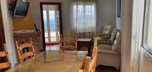 a living room with a table and a couch and a chair at Casa el corzo in La Iruela