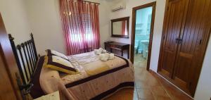 a bedroom with a wooden bed and a mirror at Casa el corzo in La Iruela +34 photos