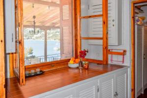 a kitchen with a window and a counter with oranges at Sea Frame in Skiathos +38 photos