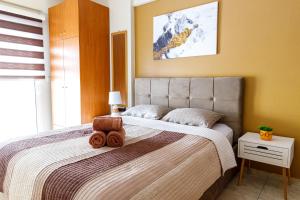 a bedroom with a bed with a teddy bear on it at Blaze Studios & Apartments in Xanthi