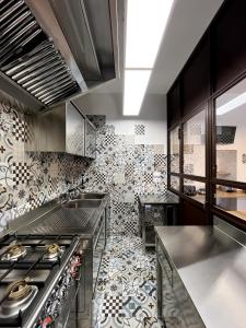 a large kitchen with a patterned wall at Eat&Stay B&B in Pompei