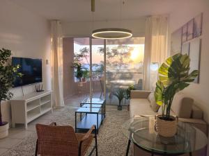 a living room with a couch and a table at Kings Palace Sea View Apartment in Paphos