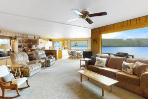 a living room filled with furniture and a large window at The Treehouse in Joseph