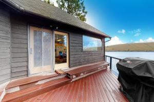 a house with a large window on a wooden deck at The Treehouse in Joseph