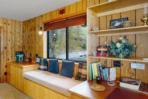 a room with a bench with pillows and a window at The Treehouse in Joseph