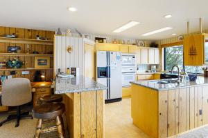 a kitchen with wooden cabinets and a white refrigerator at The Treehouse in Joseph