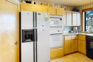 a kitchen with a refrigerator and a stove at The Treehouse in Joseph