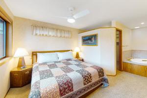 a bedroom with a bed and a bath tub at The Treehouse in Joseph