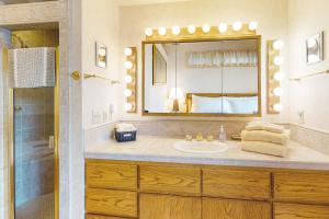 a bathroom with a sink and a mirror at The Treehouse in Joseph +26 photos