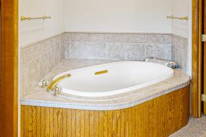 a bath tub with a gold faucet in a bathroom at The Treehouse in Joseph