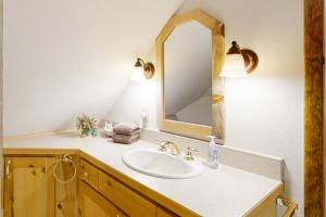 a bathroom with a sink and a mirror at The Treehouse in Joseph