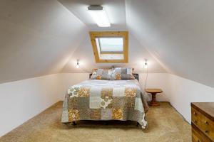 a bedroom with a bed with a quilt on it at The Treehouse in Joseph