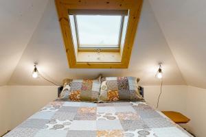 a bedroom with a bed with a window above it at The Treehouse in Joseph