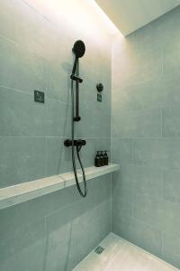 y baño con ducha con cabezal de ducha. en Atour Hotel Wuhan Optics Valley Square Yangjia Bay en Wuhan