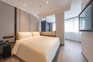a bedroom with a large white bed and large windows at Atour Hotel Hangzhou West Lake Hubin North Zhongshan Road in Hangzhou