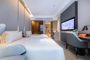 Atour Hotel Taiyuan Changfeng Business Center Wanxiang City tesisinde bir odada yatak veya yataklar