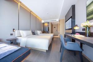 Ένα ή περισσότερα κρεβάτια σε δωμάτιο στο Atour Hotel Jincheng Development Lanhua Road +19 φωτογραφίες