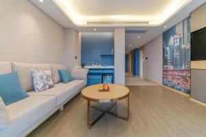 a living room with a couch and a table at Atour Hotel Chongqing Yongchuan High-Speed Xinglong Lake in Yongchuan