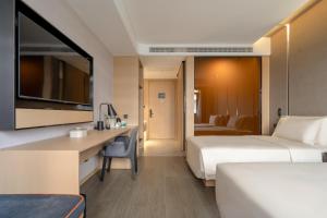 Кровать или кровати в номере Atour Hotel Yixing Middle Yangquan Road