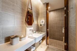 a bathroom with a sink and a toilet at Atour Hotel Chifeng Hongshan Sport Center in Chifeng +16 photos