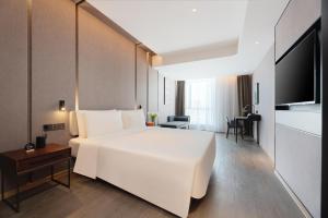 Ένα ή περισσότερα κρεβάτια σε δωμάτιο στο Atour Hotel Lanzhou Xiguan Zhangye Road Pedestrian Street